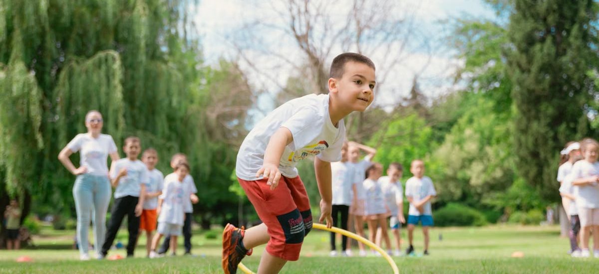 Kids enjoy outdoor fun with hula hoops in a vibrant park setting.